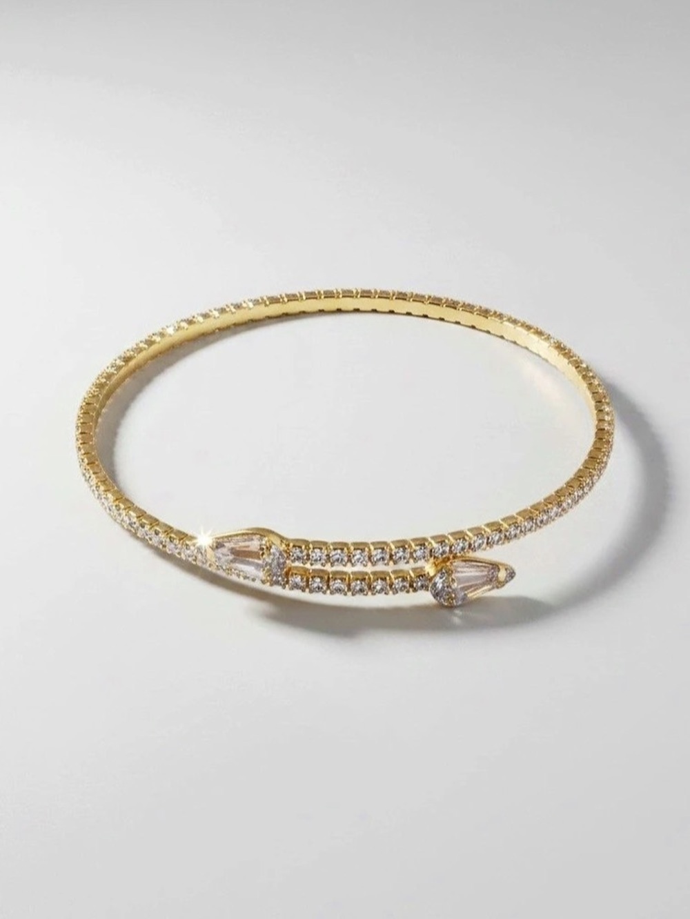 Dry goods Gold Wrap Around Arrow Bracelet, good condition one gem missing in fro